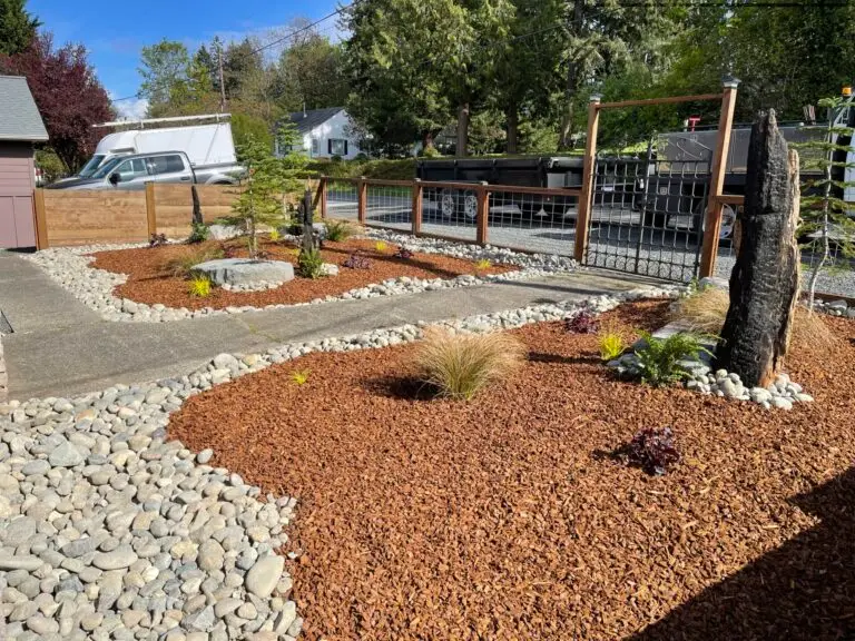gravel path with river rock and barked garden area