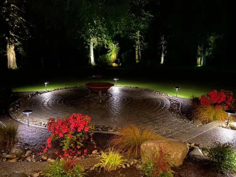 Hardscaped backyard in the dark with fountain in the middle